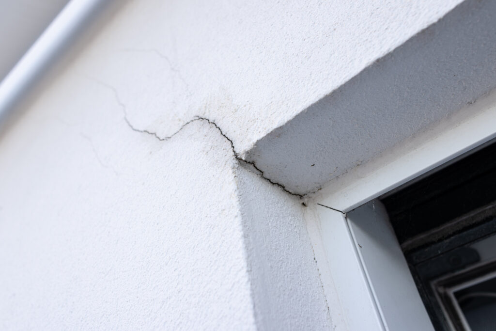 Stucco crack repair on a damaged exterior wall