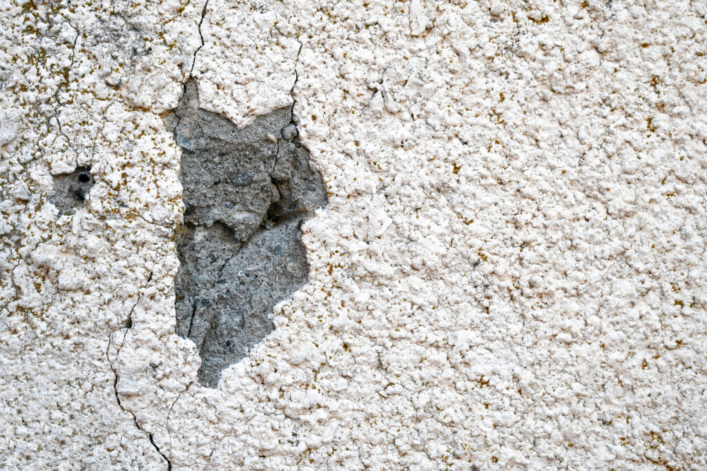 Stucco crack repair on a damaged exterior surface