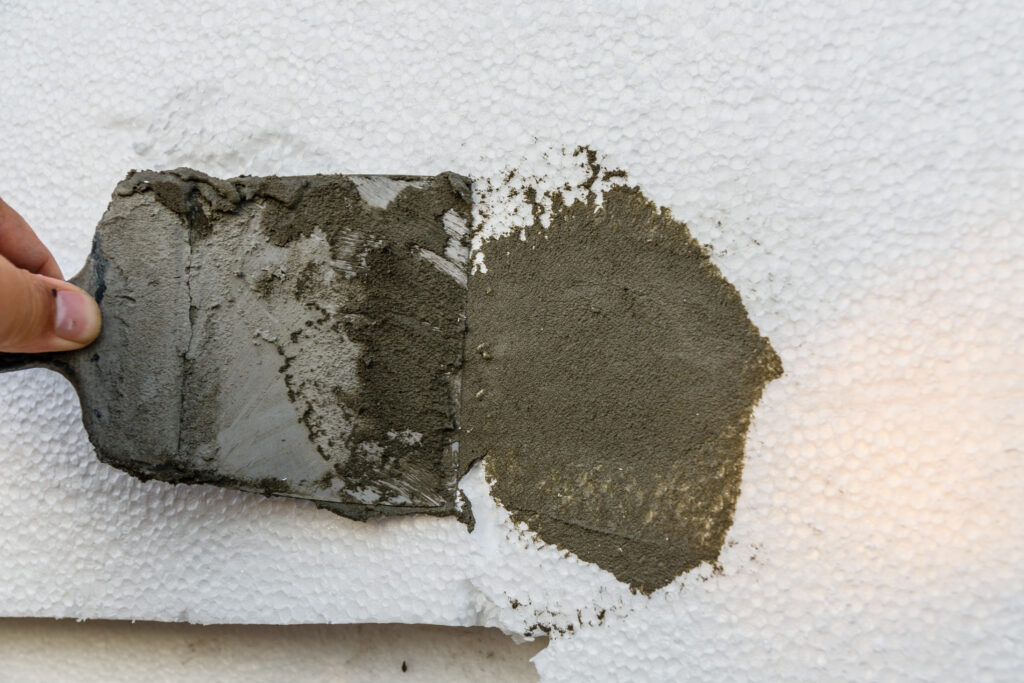 Residential stucco repair on a damaged exterior wall